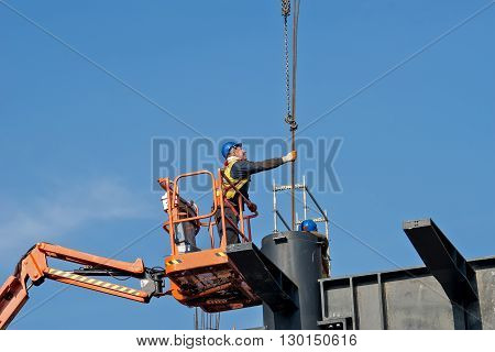 Belgrade Serbia - February 27 2016: Construction worker on a raised platform puts the reinforcement of the pillars of the building