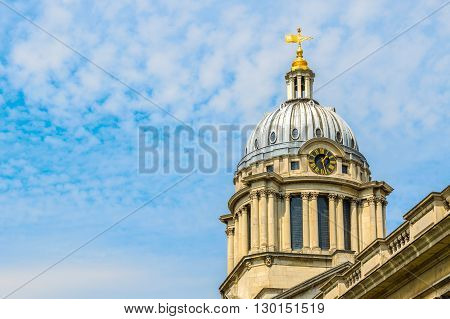 Clock tower against a blue sky with altocumulus clouds in Old Royal Naval College University of Greenwich London