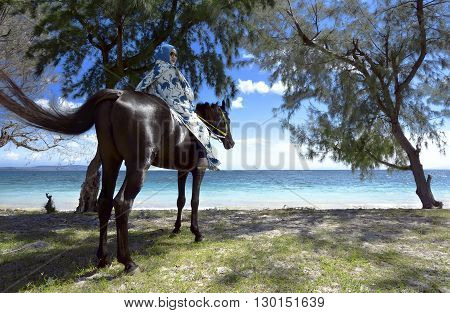 Muslim woman wearing hijab riding horse on puru kambera beach sumba indonesia