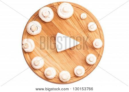 Play healthy foods isolated on white background. Champignon mushrooms on a wooden cutting board with cheese