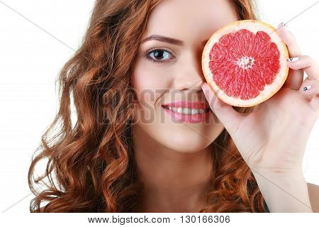 Portrait of a young beautiful woman with pink grapefruit on a white background.