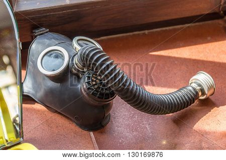 A photo with Old gas mask with hose