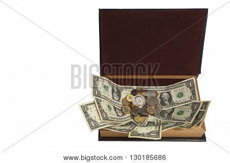 A variety of monetary denominations of coins on the paper in an open casket: money to money cling (stick).