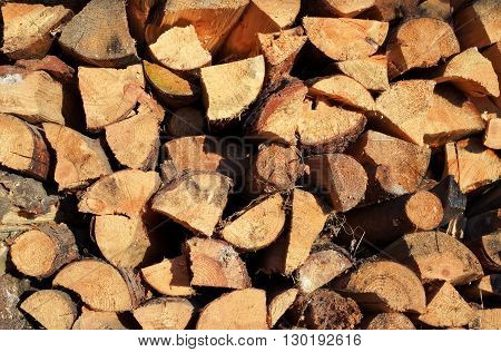 Pile of chopped fire wood prepared for winter. Old firewood pile background