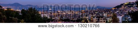 Sunset on Naples cityscape with Capri and Sorrento coast in background. Italy