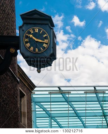 Old street victorian clock near a modern canopy. London, UK