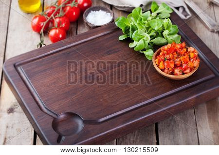 Salsa sauce and ingredients with fresh salad Dark steak cutting bord wooden background Copy space