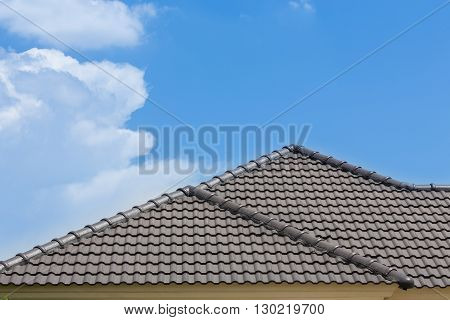 Black Tile Roof Of House With Blue Sky And Cloud Background