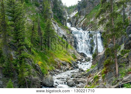 Mystic Falls on the Little Firehole River beautifully curly between rocky shores Yellowstone National Park