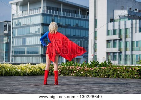Rear view of superwoman looking at the city