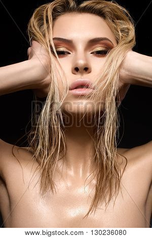 Beautiful girl with a wet hair and creative bright makeup
