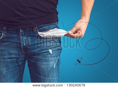 Poor man in jeans with empty pocket and drawn fly concept
