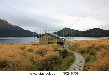 Scene in the Fjordland National Park New Zealand. Public hut. Green Lake tramping route.