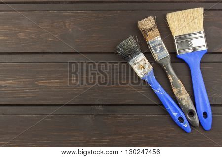 Paint brush on wooden background. Sales of paints and brushes. Housework. Supplies for painters.
