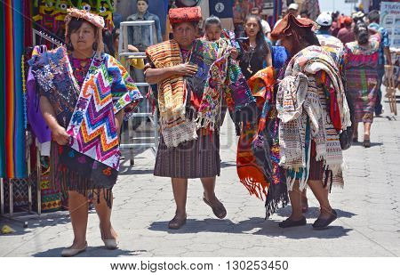 CHICHICASTENANGO GUSTEMALA APRIL 29 2016: Portrait of a Mayan woman saling table cloth. The Mayan people still make up a majority of the population in Guatemala,