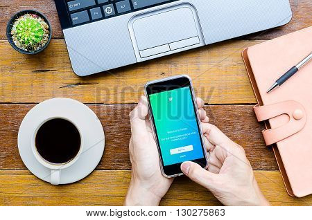CHIANG MAITHAILAND - FEB 072016 : Man holding a iPhone 6s with Twitter application.Twitter is an online social networking and microblogging service that enables users to send and read 