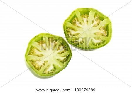 Sliced green ox heart tomato Solanum lycopersicum showing many small seed compartments called locules and a nice yellowish flesh.
