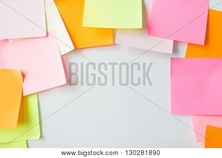 business, information, memo, management and education concept - close up of blank paper stickers on cork board