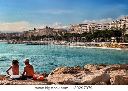CANNES FRANCE - JULY 5 2015: The beach in Cannes. Cannes located in the French Riviera. The city is famous for its Film Festival. FRANCE - JULY 5 CANNES 2015