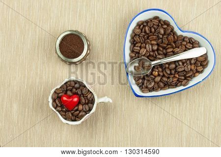 Roasted coffee beans on the kitchen table. Fresh coffee. Preparation of hot coffee. Refreshing drink. Sales of coffee beans. Advertising for coffee shop. We love fresh coffee.