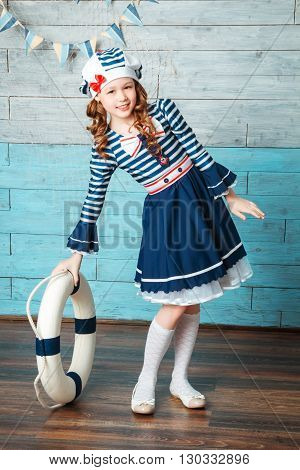 little girl holding a life preserver vest
