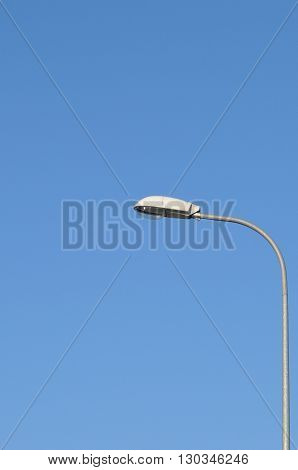 Lamp street lighting on the background of blue sky.