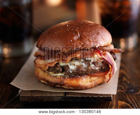 juicy bacon cheeseburger on rustic table
