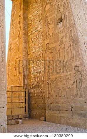 The inner part of the entrance gate of the Khonsu Temple decorated with the numerous ancient reliefs depicting the myths about the God of Moon - Khonsu Karnak Complex Luxor Egypt.