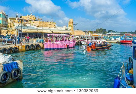 ACRE ISRAEL - FEBRUARY 20 2016: The boat trips are very popular attraction in old Akko the medieval town looks great from the sea on February 20 in Acre.