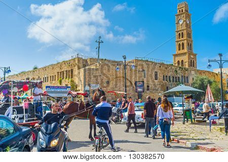 ACRE ISRAEL - FEBRUARY 20 2016: The clock tower of Khan al-Umdan (Inn of Columns) rises over the medieval Akko and is the largest and best preserved khan in Israel on February 20 in Acre.