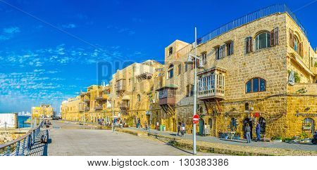 TEL AVIV ISRAEL - FEBRUARY 25 2016: The street stretches along the old housing of the port quarter on February 25 in Tel Aviv.