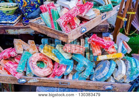 The flea market stall offers the vintage wooden letters with crumbled paint for the original interior design Jaffa Tel Aviv Israel.