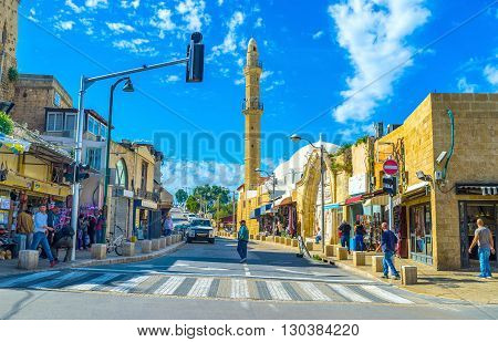 TEL AVIV ISRAEL - February 25 2016: The slender stone minaret of Mahmoudiya Mosque rises over the medieval street of Jaffa on February 25 in Tel Aviv.