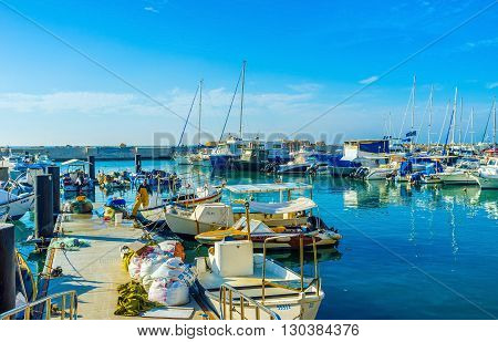 TEL AVIV ISRAEL - February 25 2016: The fishing boats and yachts in the old port of Jaffa on February 25 in Tel Aviv.