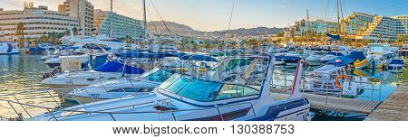 EILAT ISRAEL - FEBRUARY 23 2016: The moored motor boats slowly bob on the waves in Lagoona on February 23 in Eilat.