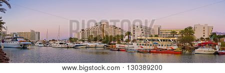 EILAT ISRAEL - FEBRUARY 23 2016: The view from the bridge on the wide marina and the tourist neighborhood located around it on February 23 in Eilat.