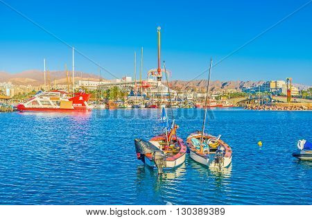 EILAT ISRAEL - FEBRUARY 23 2016: The city center with amusement park harbor and the rocky mountains on the background on February 23 in Eilat.