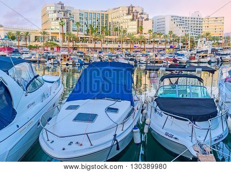 EILAT ISRAEL - FEBRUARY 23 2016: The lines of white motor boats in port are ready for the trips and fishing tours on February 23 in Eilat.