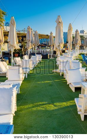 EILAT ISRAEL - FEBRUARY 24 2016: The white benches with the fluffy pillows for the best relax on central beach on February 24 in Eilat.