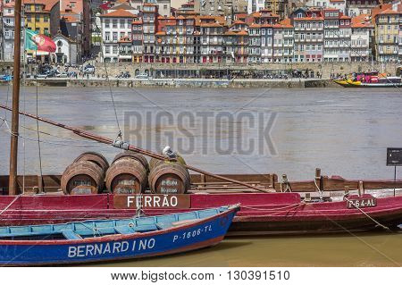 PORTO, PORTUGAL - APRIL 21, 2016: Port with wine barrels on a ship in Porto, Portugal