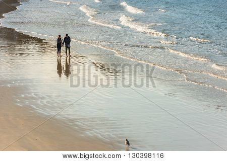 Happy Romantic Couple Walking On The Atlantic Beach