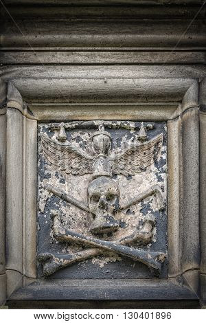 Stone skull relief on Glasgow cathedral in Scotland.