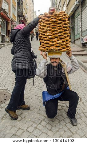 Istanbul Turkey -January 3 2015: A vendor sells simit a type of Turkish bread in the streets of Istanbul.