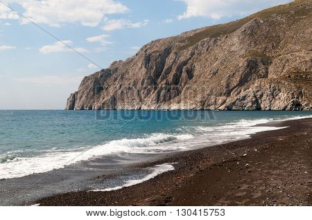 Black volcanic beach at Kamari Santorini Greece
