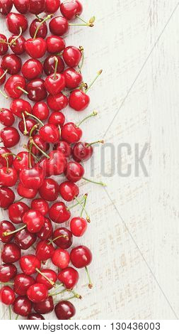 Cherries Fresh cherries on a white surface, seen from above, blank space