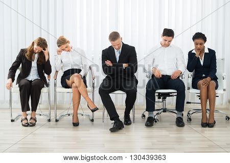 Businesspeople On A Chair Sleeping In A Waiting Room
