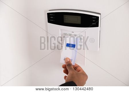 Close-up Of Businesswoman Hand Holding Keycard To Open Door