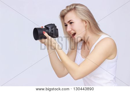 Happy woman holding camera and shooting something