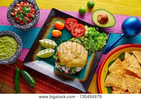 Gordita mexican fried puff corn taco filled with pastor meat lettuce and cream