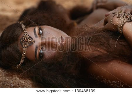 Attractive young tribal woman in ethnic jewelry